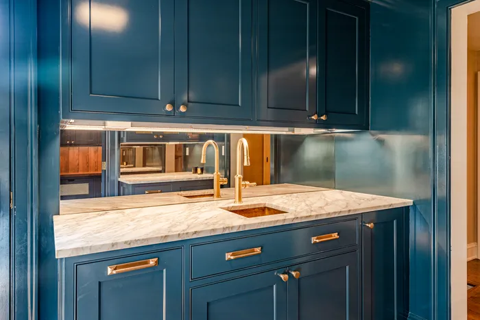 Blue painted kitchen cabinets with marble countertop by TCM Finishes in Chester County PA