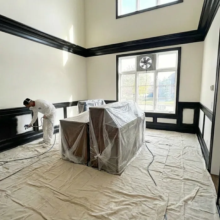 Professional spray painting application in high foyer ceiling in Chester County home