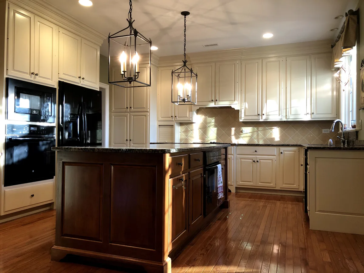 Refinished cream kitchen cabinets with dark island and pendant lighting, Chester Springs, PA