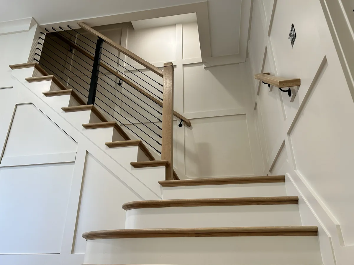 Painted staircase with board-and-batten wainscoting in crisp white, Chester Springs, PA