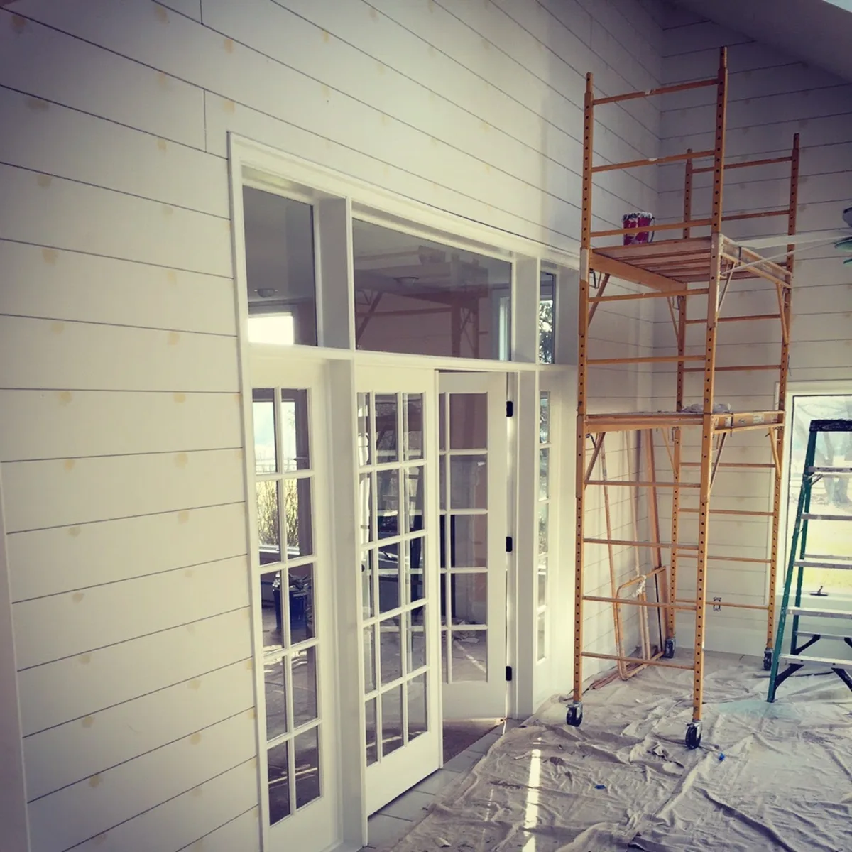 Interior painting in progress on shiplap walls with French doors, Downingtown, PA