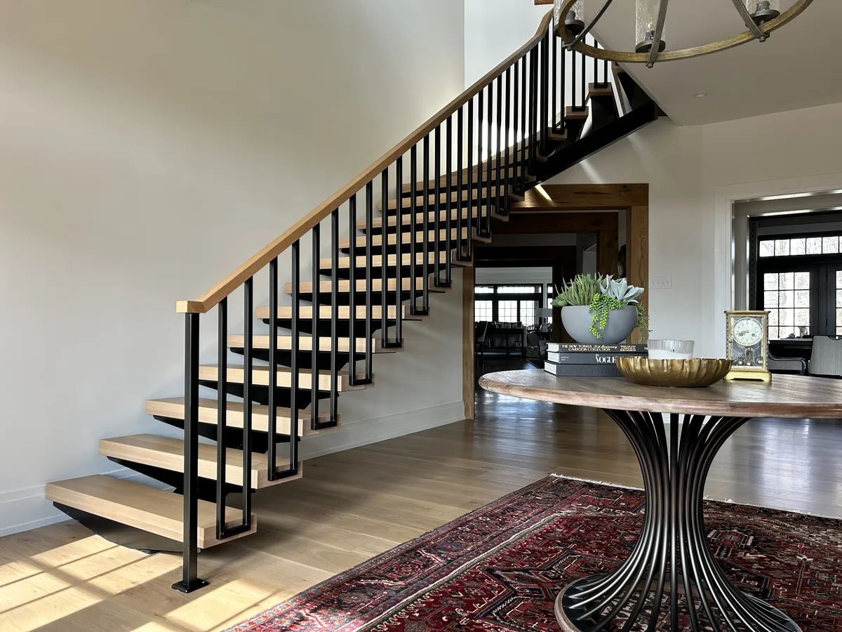 Painted foyer with floating staircase and modern metal railing, Malvern, PA