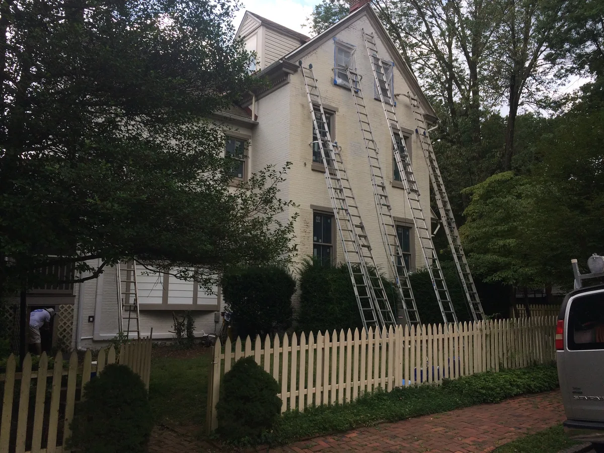 Exterior painting in progress on a painted brick colonial home, West Chester, PA
